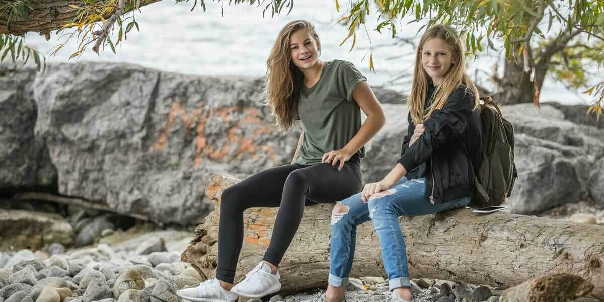 teens sitting on a rock